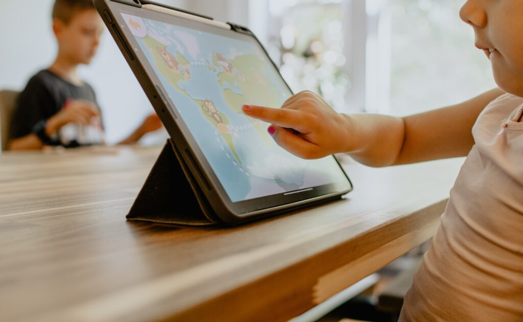 Child using an ipad in a room